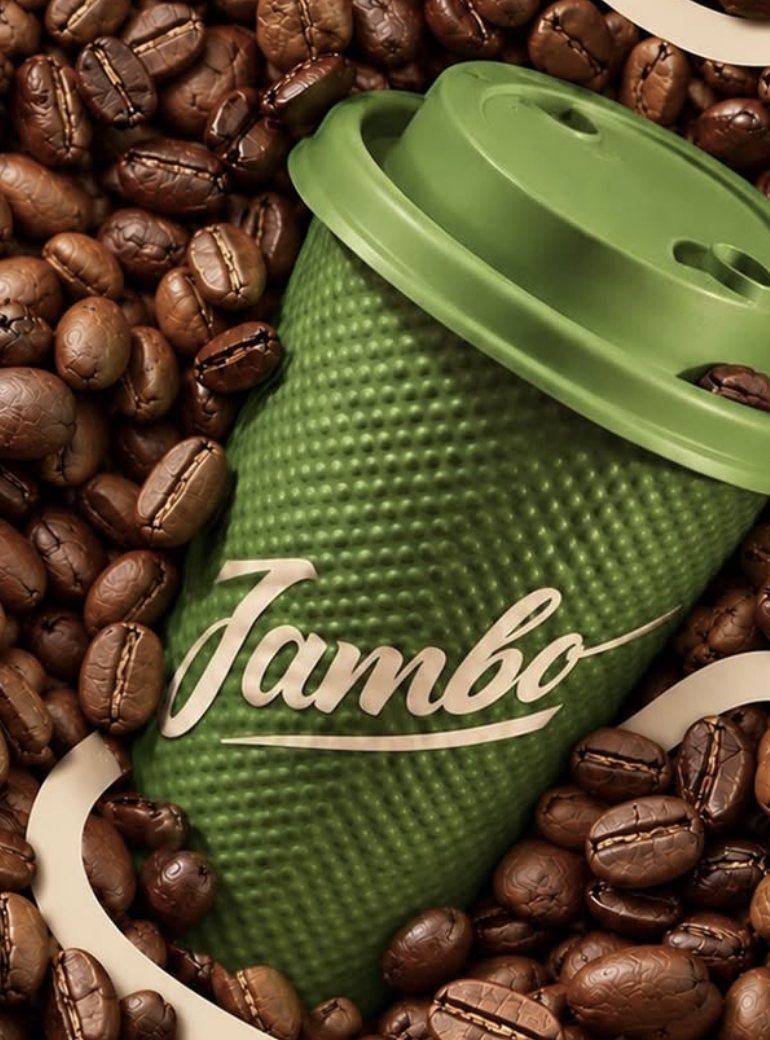 A green dotted Jambo cup with the script logo, lying in roasted coffee beans
